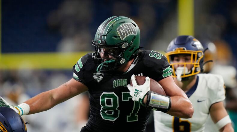 Ohio tight end Will Kacmarek (87) pushes away a defender during the first half of the Mid-American Conference championship NCAA college football game against Toledo, Saturday, Dec. 3, 2022, in Detroit. (AP Photo/Carlos Osorio)