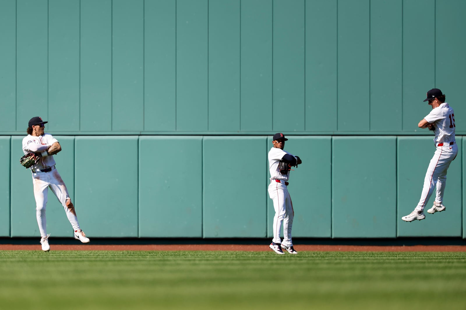 Boston Red Sox's Jarren Duran, left, center fielder Ceddanne Rafaela and right fielder Roman Anthony celebrate defeating the Tampa Bay Rays in a baseball game, Sunday, July 13, 2025, in Boston. (AP Photo/Greg M. Cooper)