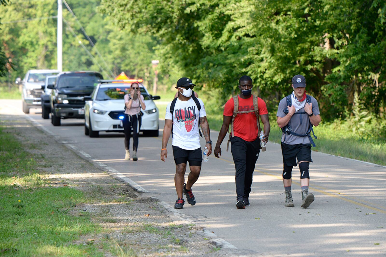 88th Force Support Squadron members Staff Sgt. Jamille Hicks (left), Staff Sgt. Melchizedek Martin (center) and Air Force Institute of Technology student 1st.Lt. Mike Hughes participate in the Airman’s Fight Against Social Injustice and For Diversity Inclusion 5K Ruck March at Wright-Patterson Air Force Base, July 10. U.S. AIR FORCE PHOTO/TY GREENLEES