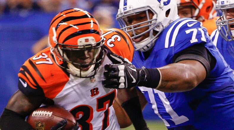 INDIANAPOLIS, IN - SEPTEMBER 3: Chris Lewis-Harris #37 of the Cincinnati Bengals runs the ball after an interception as Denzelle Good #71 of the Indianapolis Colts grabs for the tackle at Lucas Oil Stadium on September 3, 2015 in Indianapolis, Indiana. (Photo by Michael Hickey/Getty Images)