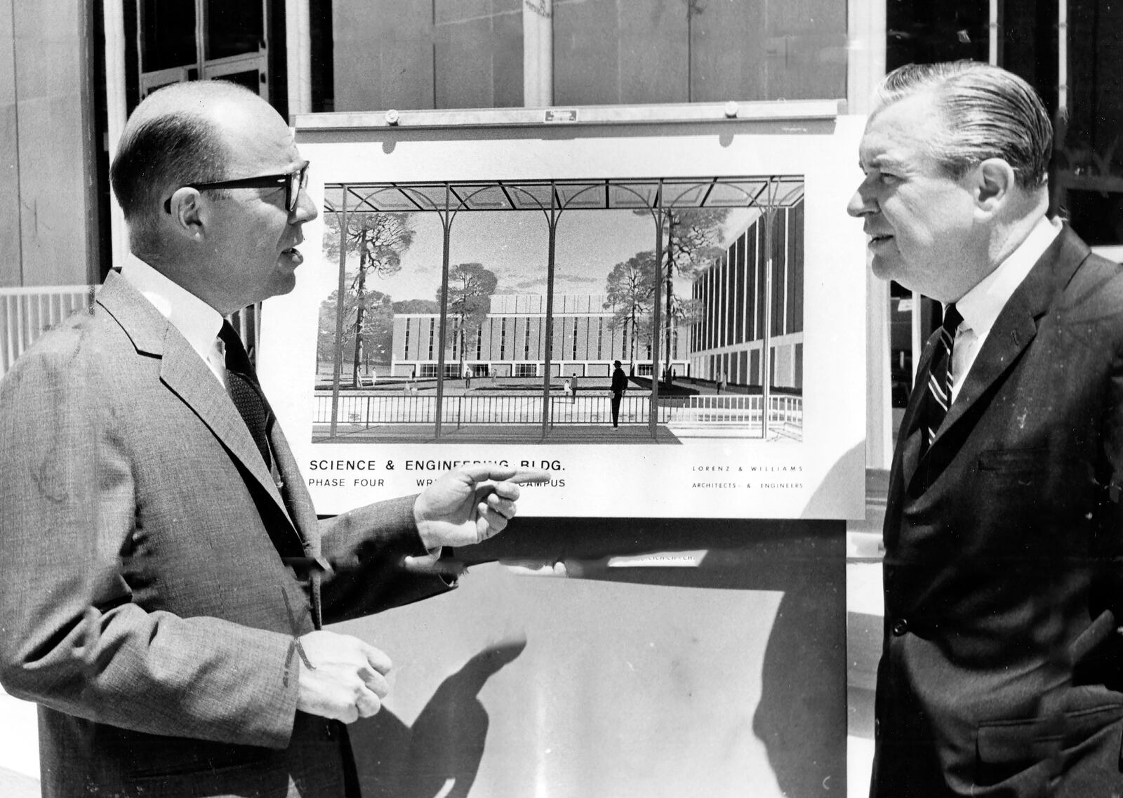 Robert S. Oelman, chairman of the Wright State university advisory board and Ohio Gov. James A. Rhodes view architect's sketch of a new science and engineering building at ground breaking ceremonies held in June 1966. It was the the start of the fourth building on the campus. DAYTON DAILY NEWS ARCHIVE