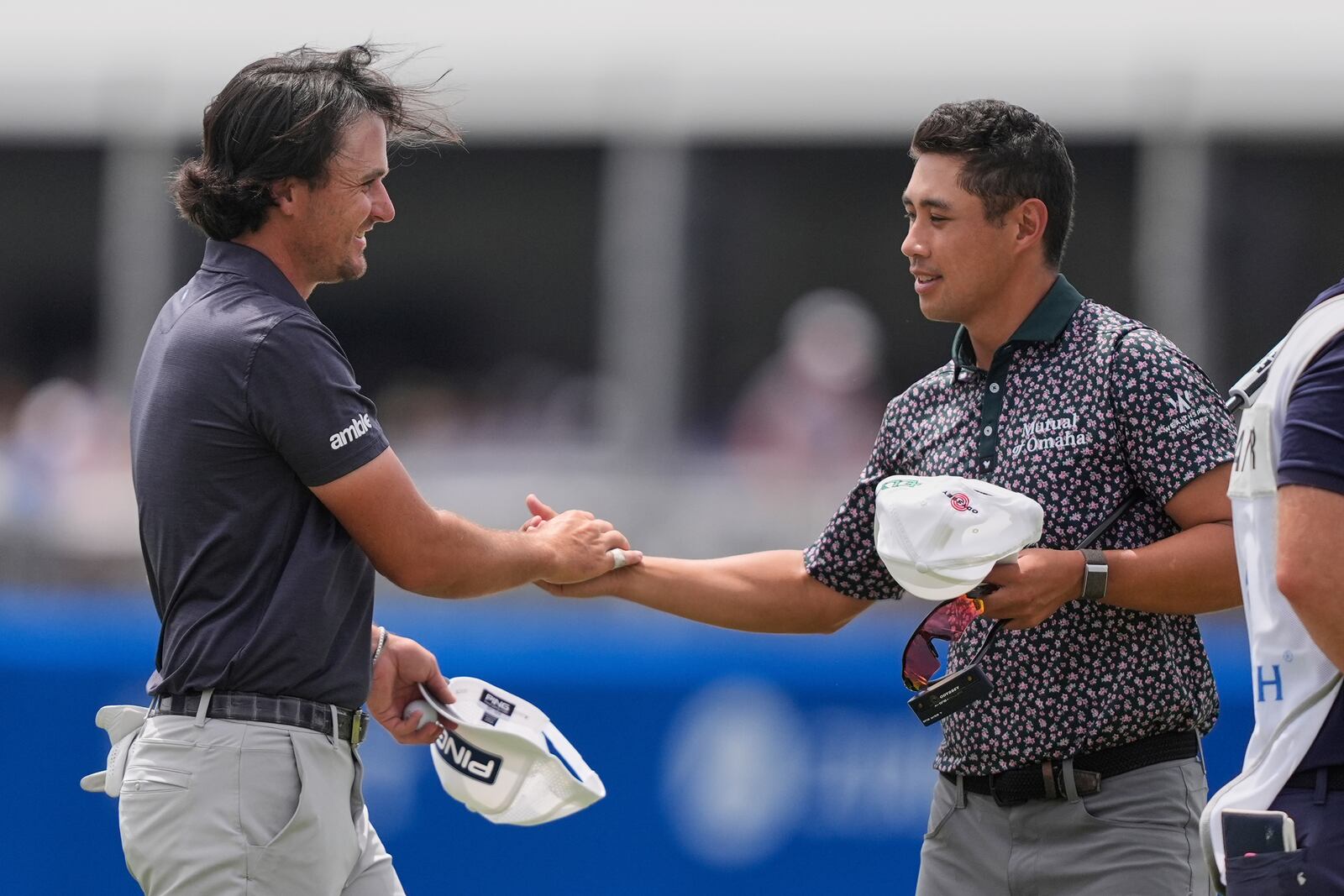 Kevin Velo, left, greets teammate Isaiah Salinda after they set a course record since the current team format was instituted in 2017, during the first round of the PGA Zurich Classic golf tournament at TPC Louisiana in Avondale, La., Thursday, April 24, 2025. (AP Photo/Gerald Herbert)