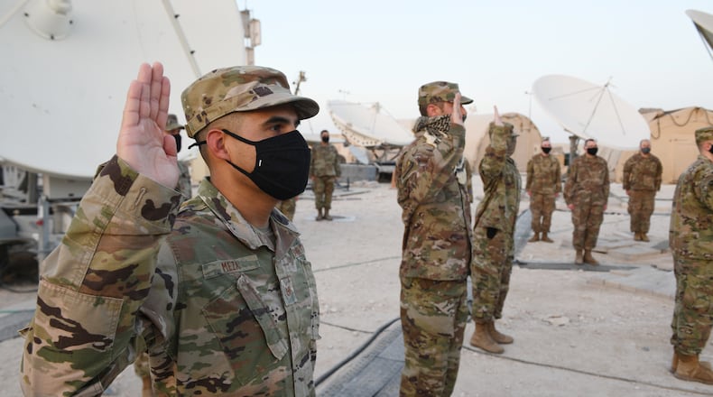 Airmen deployed to Al Udeid Air Base, Qatar, raise their right hands during an enlistment ceremony as they transferred into the Space Force on Sept. 1. The Space Force is the United States' newest service in more than 70 years. (U.S. Air Force photo by Staff Sgt. Kayla White)