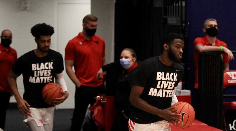 Dayton's Jalen Crutcher leads the team onto the court before a game against Eastern Illinois on Tuesday, Dec. 1, 2020, at UD Arena. David Jablonski/Staff