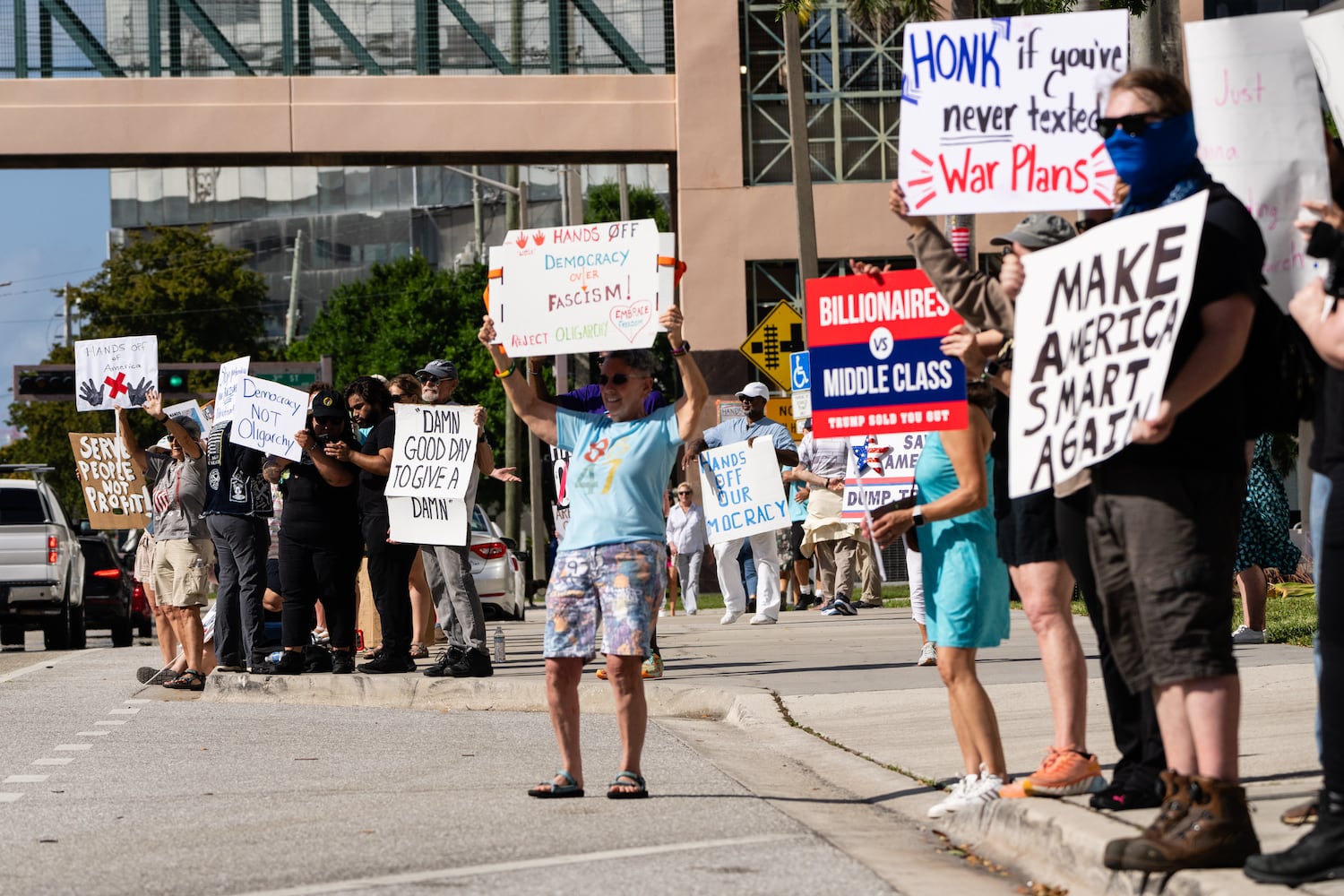 Protestors during nationwide ÒHands Off!Ó demonstrations against President Donald TrumpÕs administration, outside of the Palm Beach County Courthouse in West Palm Beach on Saturday, April 5, 2025. (Eric Lee/The New York Times)