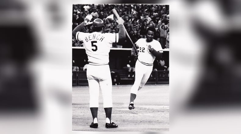 Cincinnati Reds catcher Johnny Bench is there to greet teammate Dan Driessen after he scores a run during the 1976 World Series. DDN FILE