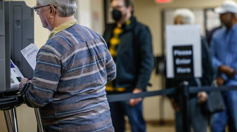 Tom Bader, left, cast his early votes near lunchtime at the Montgomery County Board of Elections Wednesday October 11, 2023. JIM NOELKER/STAFF