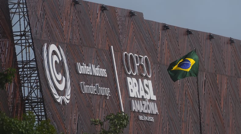A Brazilian flag flies outside the venue for the COP30 U.N. Climate Summit, Thursday, Nov. 13, 2025, in Belem, Brazil. (AP Photo/Joshua A. Bickel)