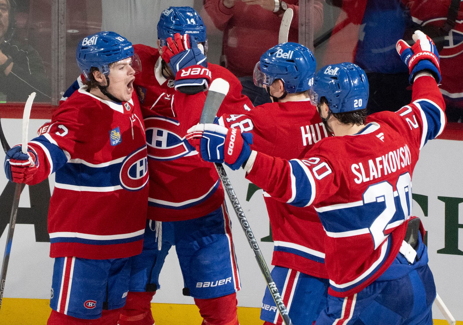 Montreal Canadiens' Cole Caufield (13) celebrates after his goal against the Washington Capitals with teammates Nick Suzuki (14), Lane Hutson (48) and Juraj Slafkovsky (20) during the second period of Game 3 of a first-round NHL hockey playoff series in Montreal, Friday, April 25, 2025. (Christinne Muschi/The Canadian Press via AP)