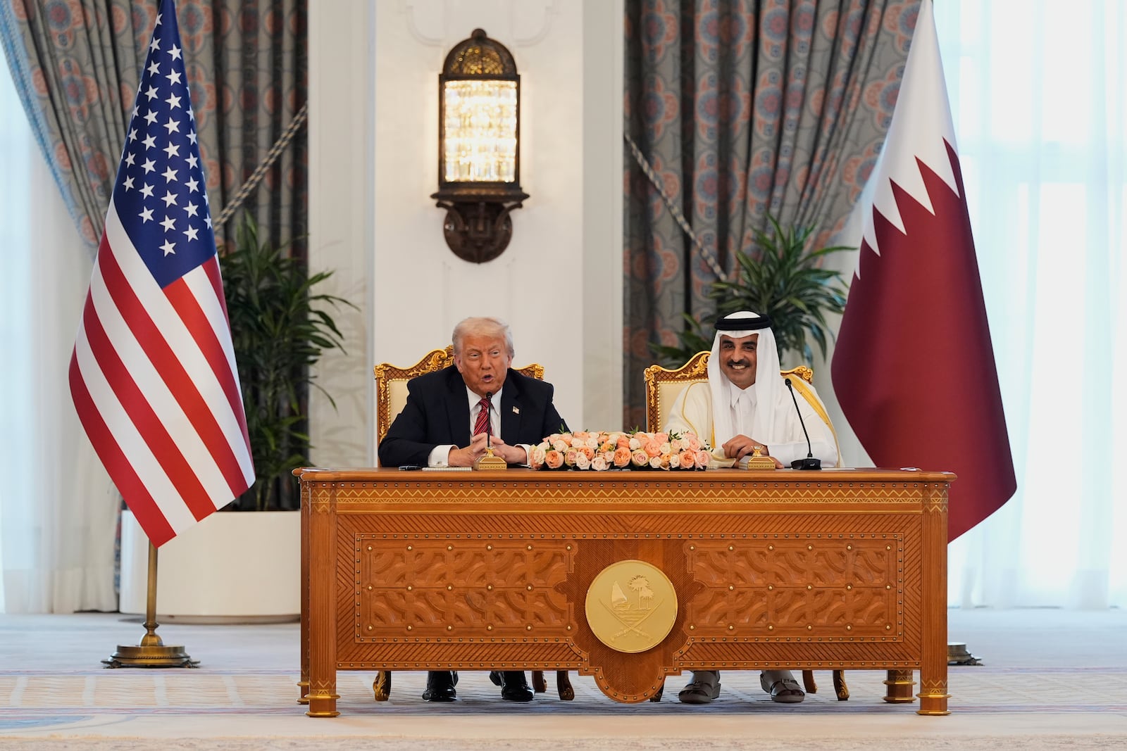 President Donald Trump and Qatar's Emir Sheikh Tamim bin Hamad Al Thani attend a signing ceremony at the Amiri Diwan in Doha, Qatar, Wednesday, May 14, 2025. (AP Photo/Alex Brandon)