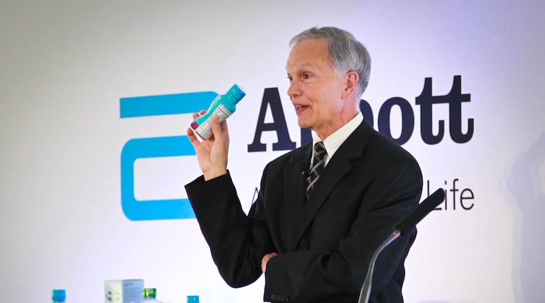 In this 2014 file photo, Abbott Executive Vice President John Landgraf holds one of the products the company makes in its Tipp City facility. JIM WITMER / STAFF