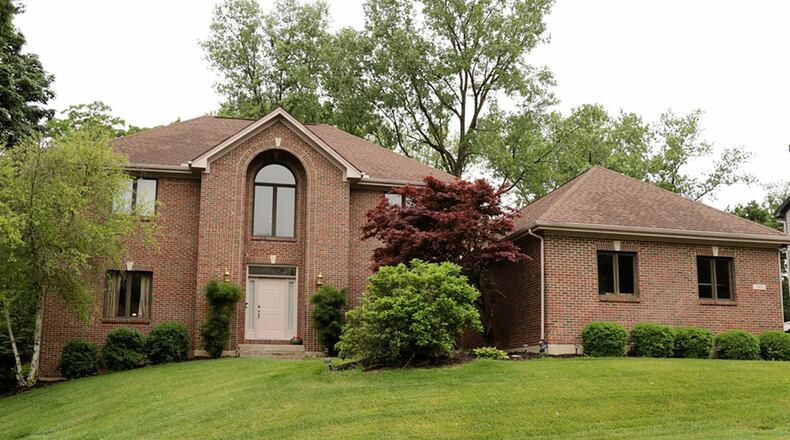 The brick 2-story has about 4,120 sq. ft. of living space. The house sits on a half-acre lot with a tree-lined back yard and a 3-car, side-entry garage. A full, finished basement features a recreation room with two daylight windows and patio doors that open to a concrete patio that is covered by the deck. CONTRIBUTED PHOTO BY KATHY TYLER