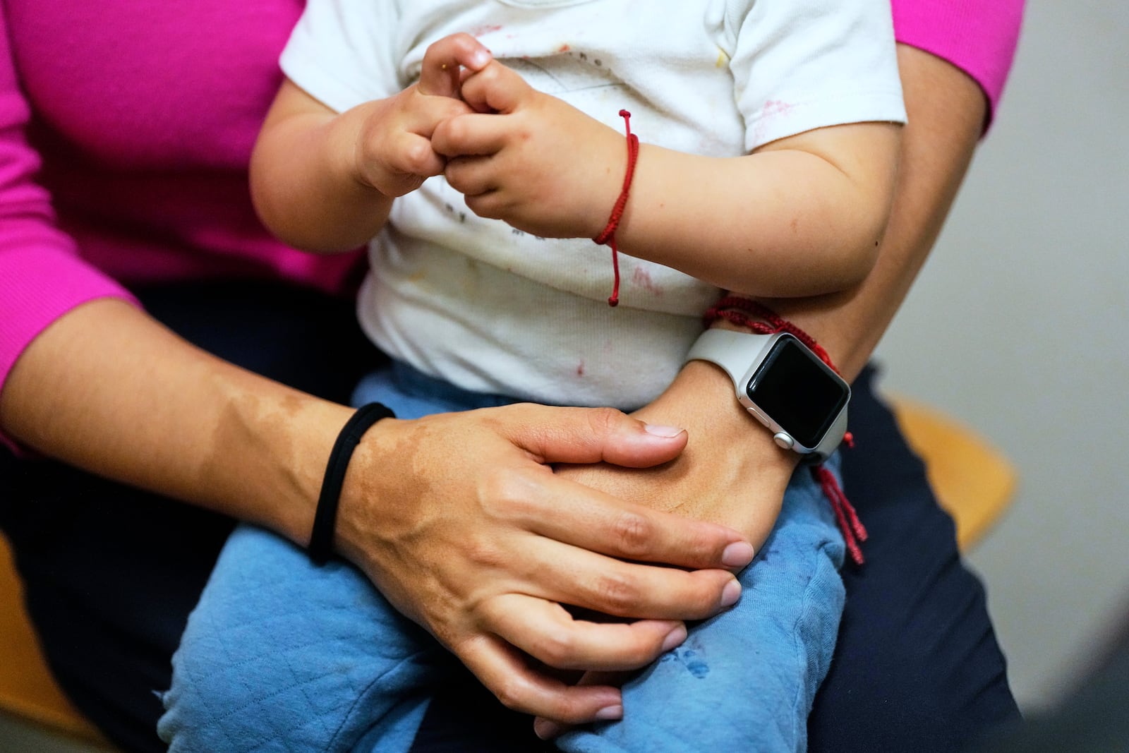 A woman and her 16-month-old son wait to see a doctor at a CommuniCARE+OLE clinic Thursday, June 26, 2025, in Davis, Calif. (AP Photo/Godofredo A. Vásquez)
