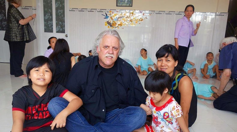 UD professor John Terzano visits with children in Hanoi during a recent visit to Vietnam. Terzano has returned to this country and Cambodia many times since the war ended in 1975. CONTRIBUTED