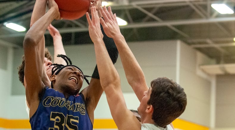 Thurgood Marshall’s Prophet Johnson tries to score against Chaminade Julienne during Saturday night’s sectional final at Springfield High School. Johnson scored 12 points and the Cougars advanced to a district final with a 57-35 victory. Jeff Gilbert/CONTRIBUTED
