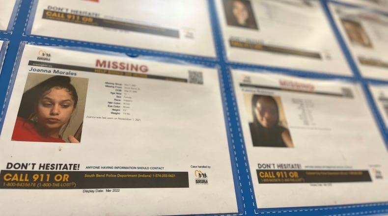 A wall of photos of missing kids posted at a Dayton-area box store. CORNELIUS FROLIK / STAFF