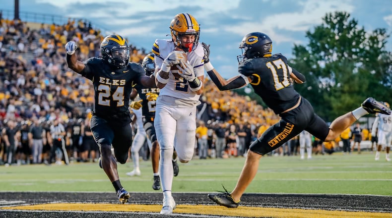 Cutline: Springfield High School senior Bop Wafer catches a touchdown pass between Centerville two defenders during their game on Friday night at Centerville Stadium. The Wildcats won 17-3. Michael Cooper/CONTRIBUTED