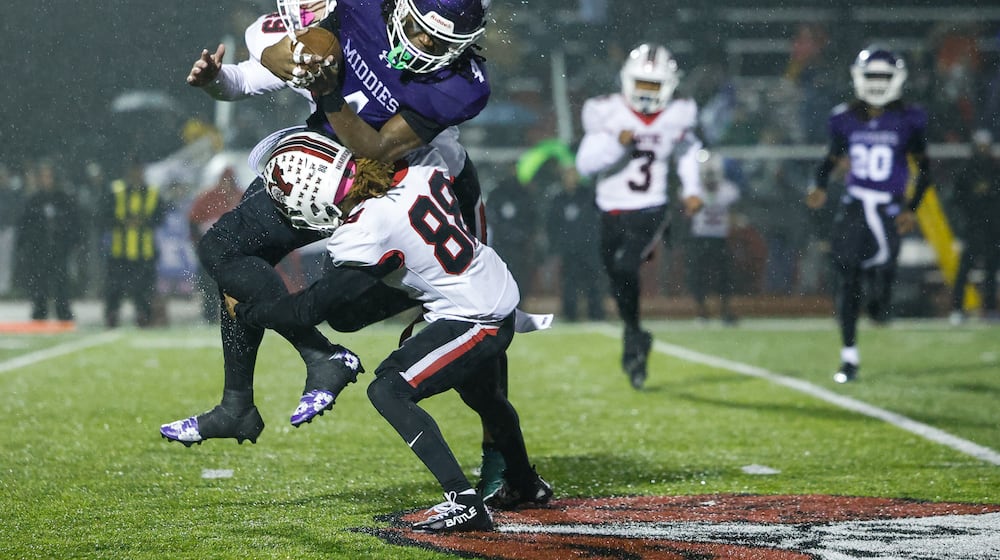 Middletown's Jordan Vann get hit by Wayne's James Dyer IV during their Division I Regional football final Friday, Nov. 21, 2025 at Trotwood Madison High School. Middletown won 21-14 to advance. NICK GRAHAM/STAFF