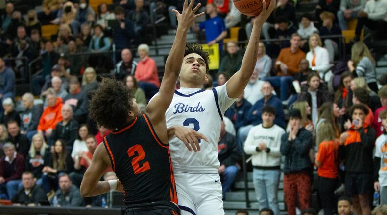 Fairmont's Dasan Doucet shoots over Beavercreek's Jamir Hymes during Friday night's district semifinal at Centerville. Doucet scored 19 points to lead the Firebirds to a 57-50 victory. Jeff Gilbert/CONTRIBUTED