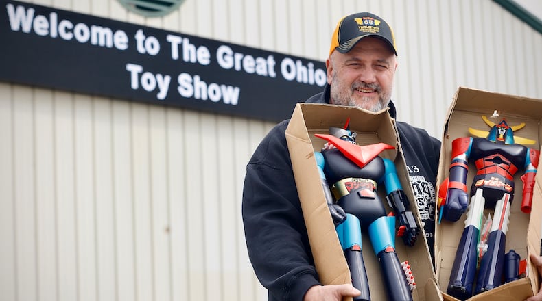 Rob Eldridge owner of the Route 68 Toy Mall in Xenia holds two 1970’s Shogun Warriors toys still in boxes Thursday, March 27, 2025. These and many other vintage toys will be shown and sold at The Great Ohio Toy Show Saturday at the Greene County Fairgrounds and Expo Center in Xenia. MARSHALL GORBY\STAFF