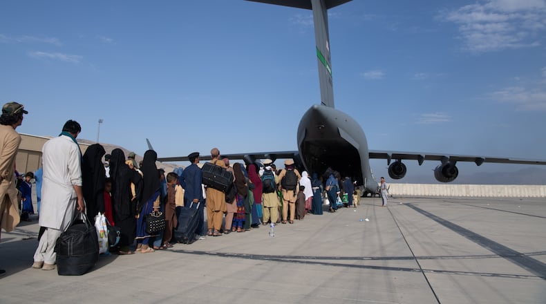 U.S. Air Force loadmasters and pilots assigned to the 816th Expeditionary Airlift Squadron, load passengers aboard a U.S. Air Force C-17 Globemaster III in support of the Afghanistan evacuation at Hamid Karzai International Airport (HKIA), Afghanistan, Aug. 24, 2021. (U.S. Air Force photo by Master Sgt. Donald R. Allen)