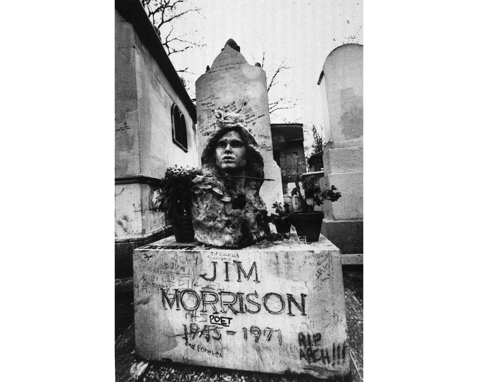 FILE- This Sept. 7, 1971 file photo shows the grave of Jim Morrison, lead singer of the rock group "The Doors," at the Pere Lachaise cemetery in Paris, France. (AP Photo/Joe Marquette,File)