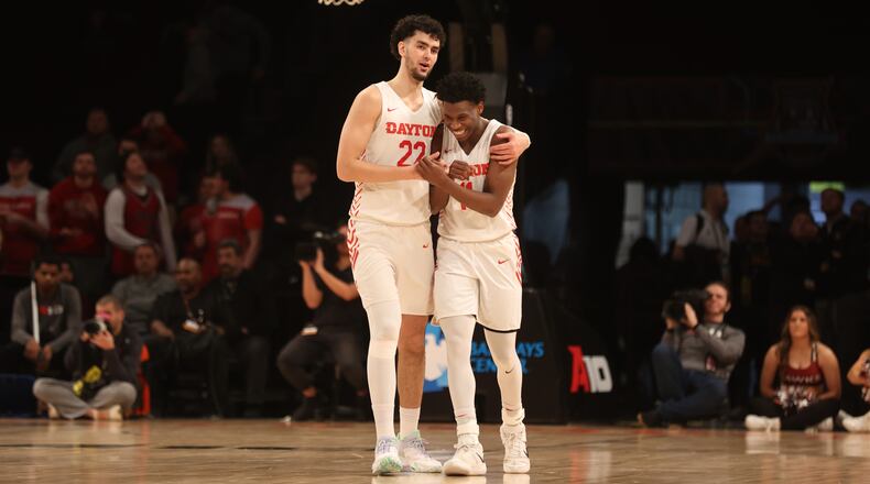 Dayton's Mustapha Amzil and Malachi Smith celebrate in the final seconds of a victory against Saint Joseph’s in the quarterfinals of the Atlantic 10 Conference tournament on Thursday, March 9, 2023, at the Barclays Center in Brooklyn, N.Y. David Jablonski/Staff