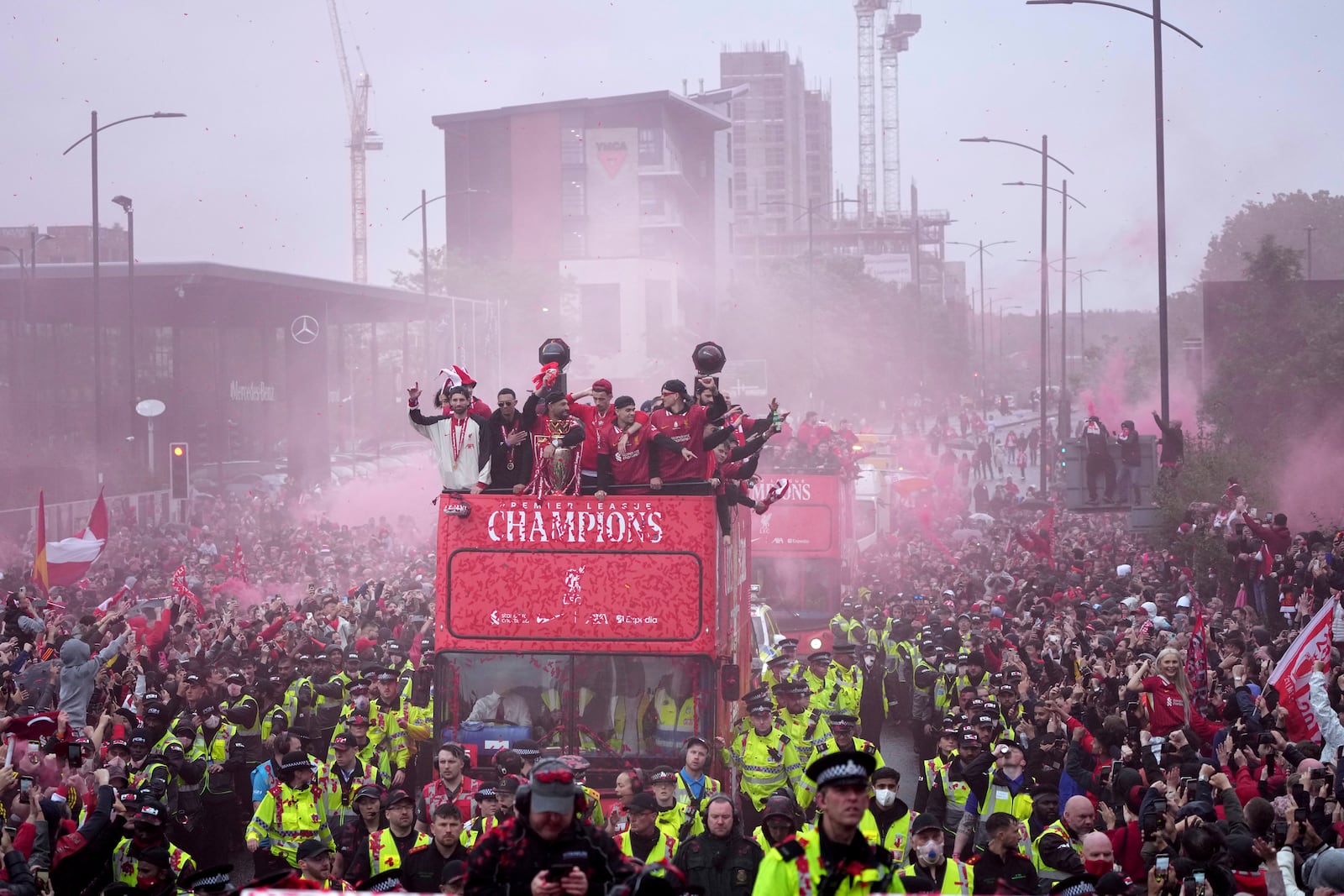 Liverpool players celebrate with the trophy on an open-top bus during the Liverpool FC Premier League victory parade in Liverpool, England, Monday, May 26, 2025.(AP Photo/Jon Super)