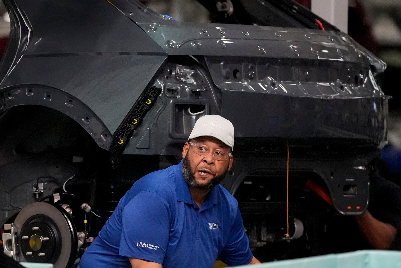 An employee works on the line during a media tour at the Hyundai Motor Group Metaplant America, Wednesday, March 26, 2025, in Ellabell, Ga. (AP Photo/Mike Stewart)