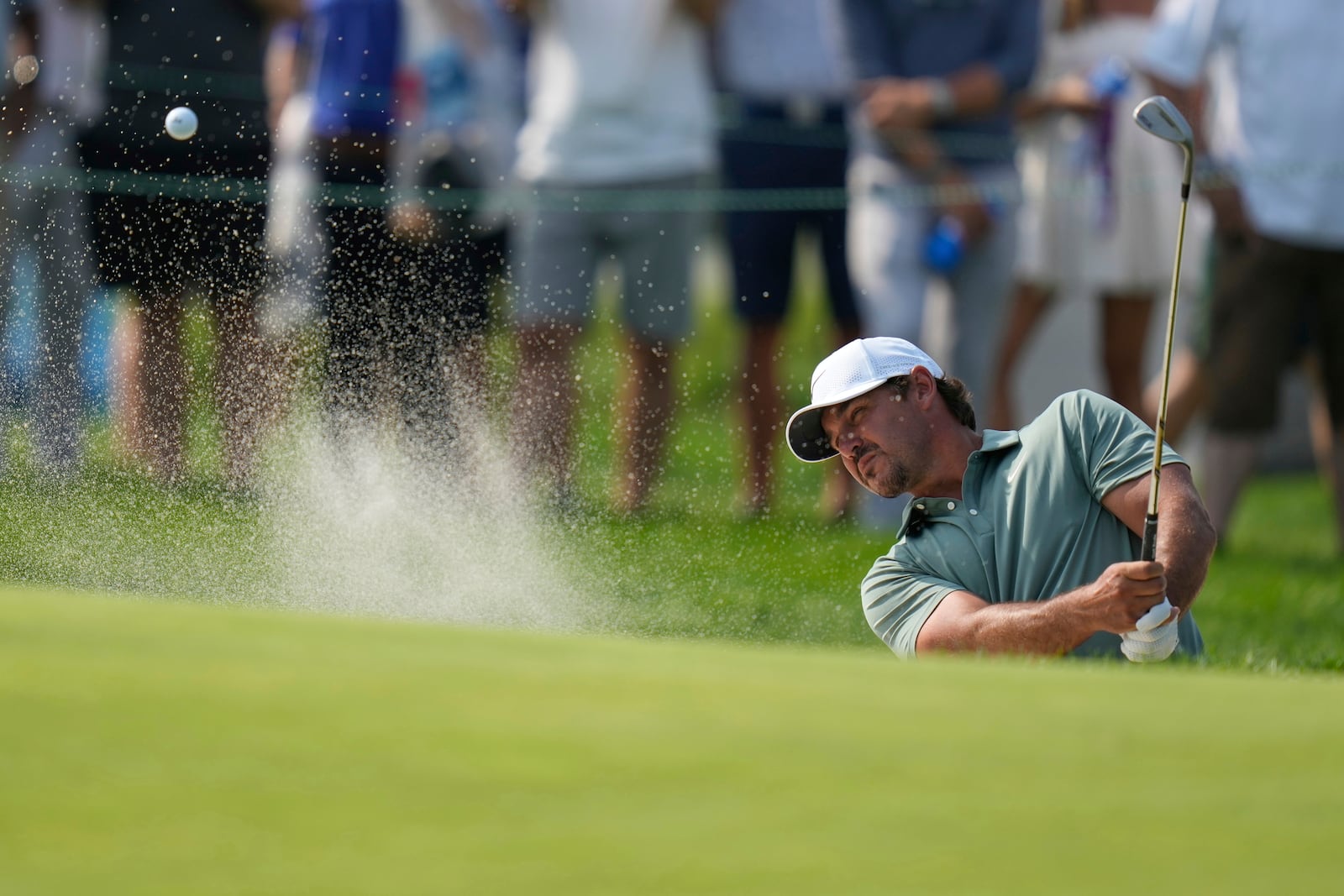 Brooks Koepka hits from a bunker on the 13th hole during the first round of the U.S. Open golf tournament at Oakmont Country Club Thursday, June 12, 2025, in Oakmont, Pa. (AP Photo/Seth Wenig)