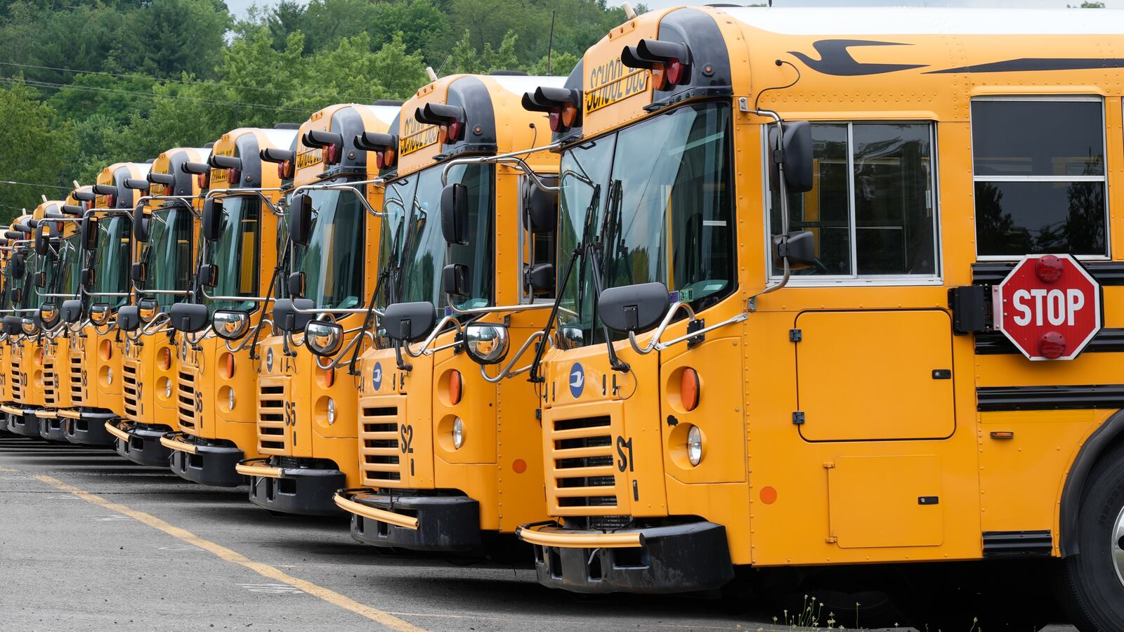 FILE - School busses are parked at a garage in Jackson Township, Pa., on July 11, 2024. (AP Photo/Gene J. Puskar, File)