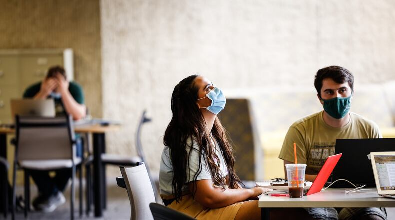 From left, Wright State University students, Anna Vandewiele from Beavercreek and Jonathan Ciero from Ranstein, Germany study at the library on campus Wednesday August 25, 2021. Weight State has issued a mask mandate in all of it buildings. JIM NOELKER/STAFF