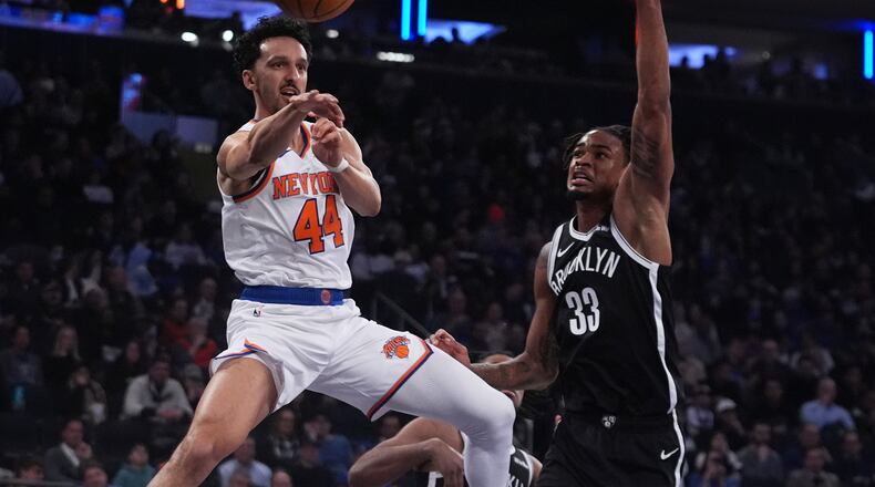 New York Knicks' Landry Shamet (44) passes away from Brooklyn Nets' Nic Claxton (33) during the first half of an NBA basketball game Wednesday, Jan. 21, 2026, in New York. (AP Photo/Frank Franklin II)