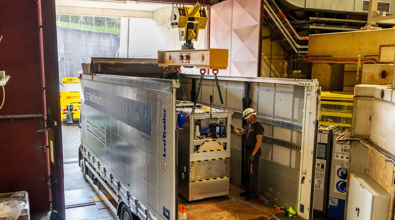 Technicians load the transportable antimatter trap into a truck from the Antimatter Factory at the European Organization for Nuclear Research (CERN) for a road test in Meyrin near Geneva, Switzerland, Tuesday, March 24, 2026. (Salvatore Di Nolfi/Keystone via AP)