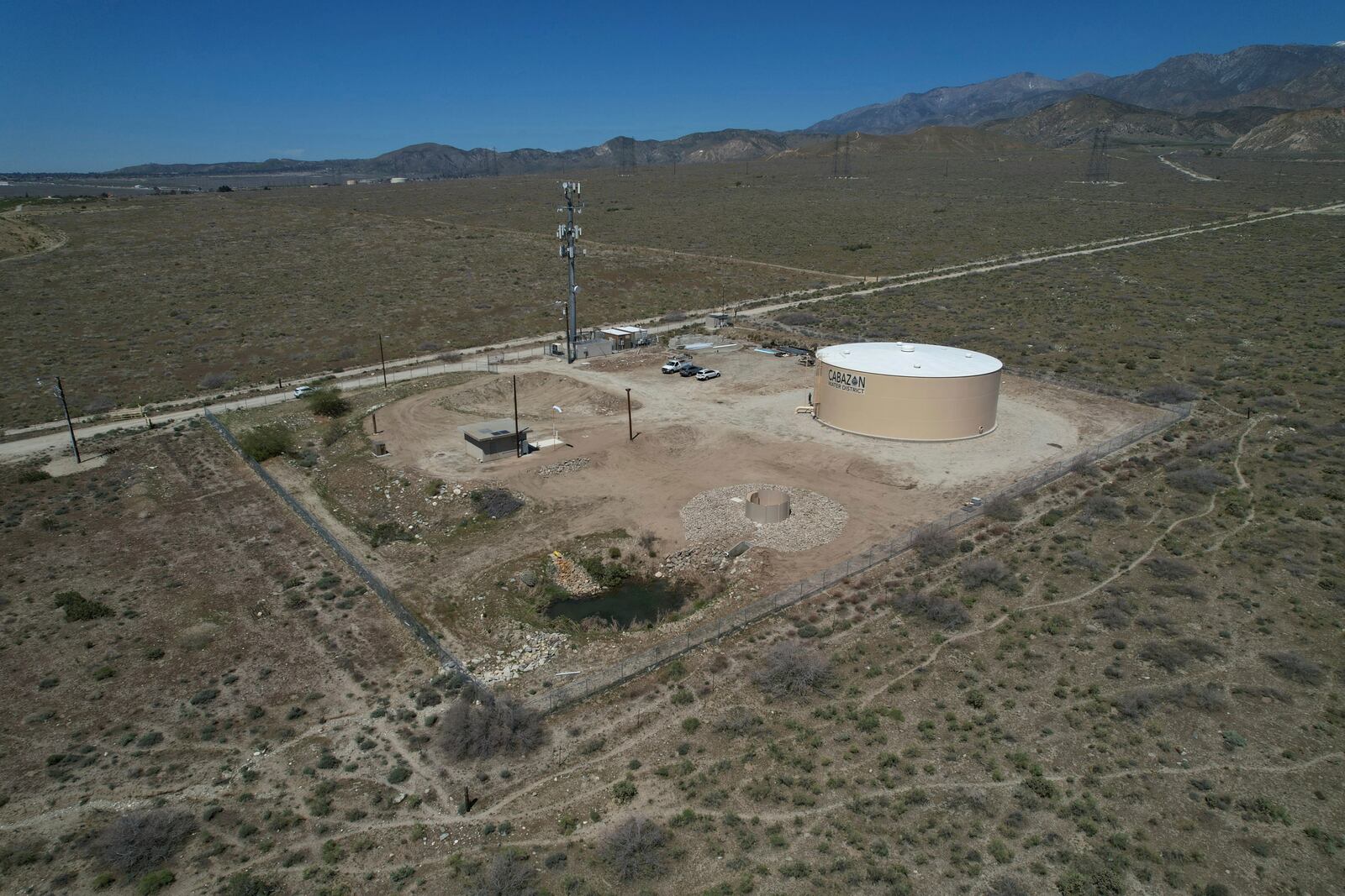 A newly installed Heli-Hydrant, a small, open tank that helicopters can rely on to get water faster for urban fires, sits in Cabazon, Calif., Friday, April 11, 2025. (AP Photo/Brittany Peterson)