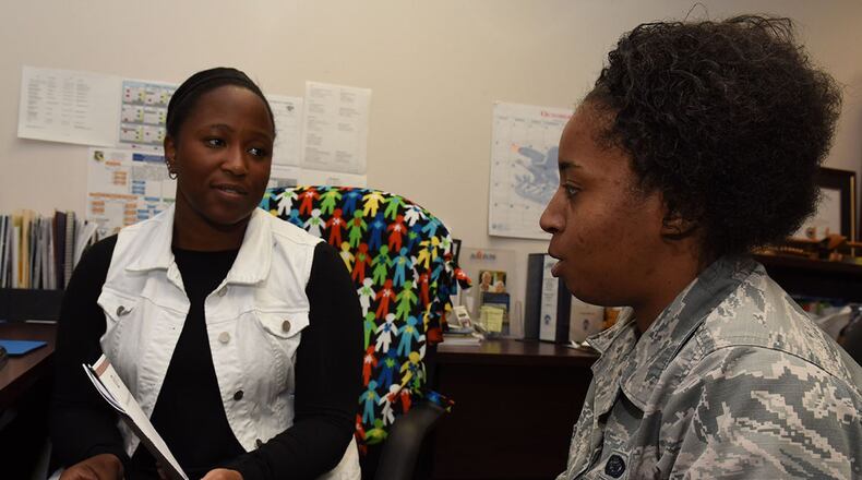 Tavonne Bridges (left), family support coordinator for the Exceptional Family Member Program at the Airman & Family and Readiness Center, Wright-Patterson Air Force Base, discusses support options with Senior Airman Jalynn Wilford, 88th Force Support Squadron Military Personnel Flight retentions counselor, Oct. 16. Bridges assists military personnel’s family members who have special needs navigate through the resources of the installation and the local community. (U.S. Air Force photo/Michelle Gigante)