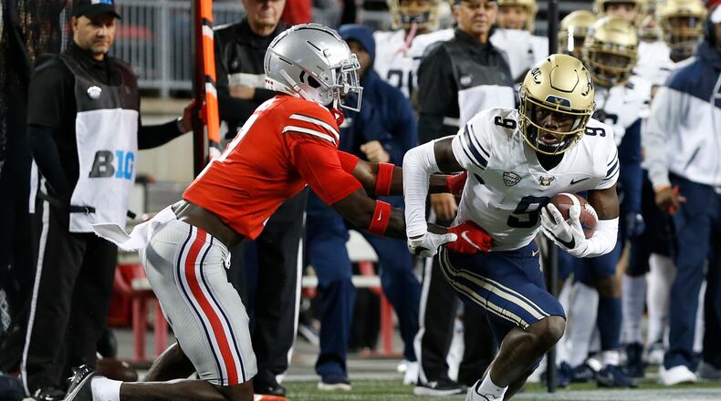 Akron receiver Konata Mumpfield, right, cuts upfield after a catch as Ohio State defensive back Sevyn Banks defends during the first half of an NCAA college football game Saturday, Sept. 25, 2021, in Columbus, Ohio. (AP Photo/Jay LaPrete)
