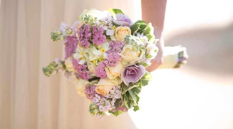 FILE - In this Dec. 14, 2017 photo, a bride holds a bouquet during her wedding. (AP Photo/Ariel Schalit, File)