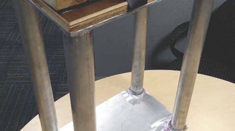 The Junior Force Warfighters Operations in the Air Force Research Laboratory Materials and Manufacturing Directorate hope to patent the new and improved milk stool for the C-130 aircraft. (U.S. Air Force photo/J.D. Bales)