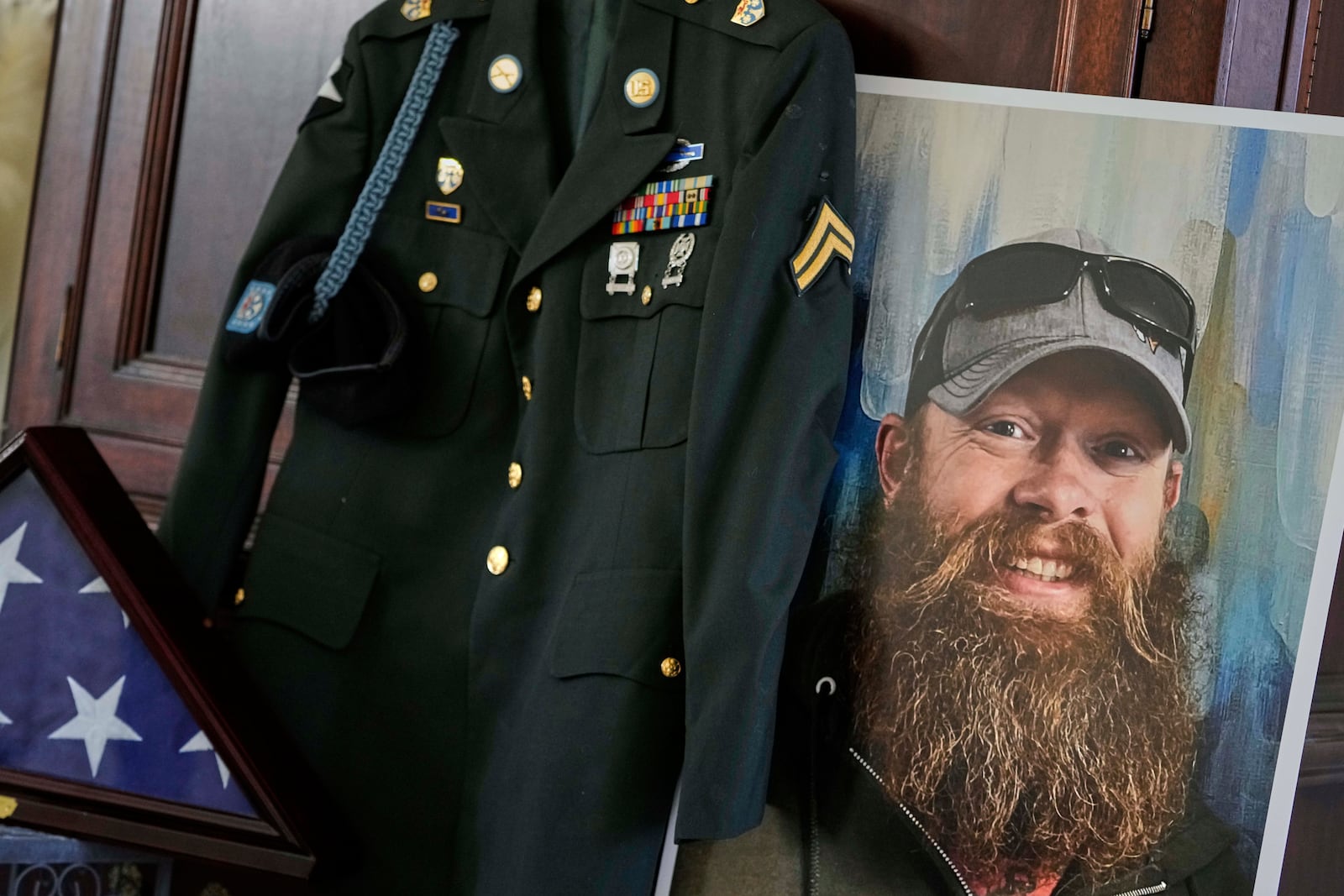 The Army dress uniform and photo of the late Christopher Pelkey is shown at his mother's home, Wednesday, May 7, 2025, in Chandler, Ariz. (AP Photo/Matt York)