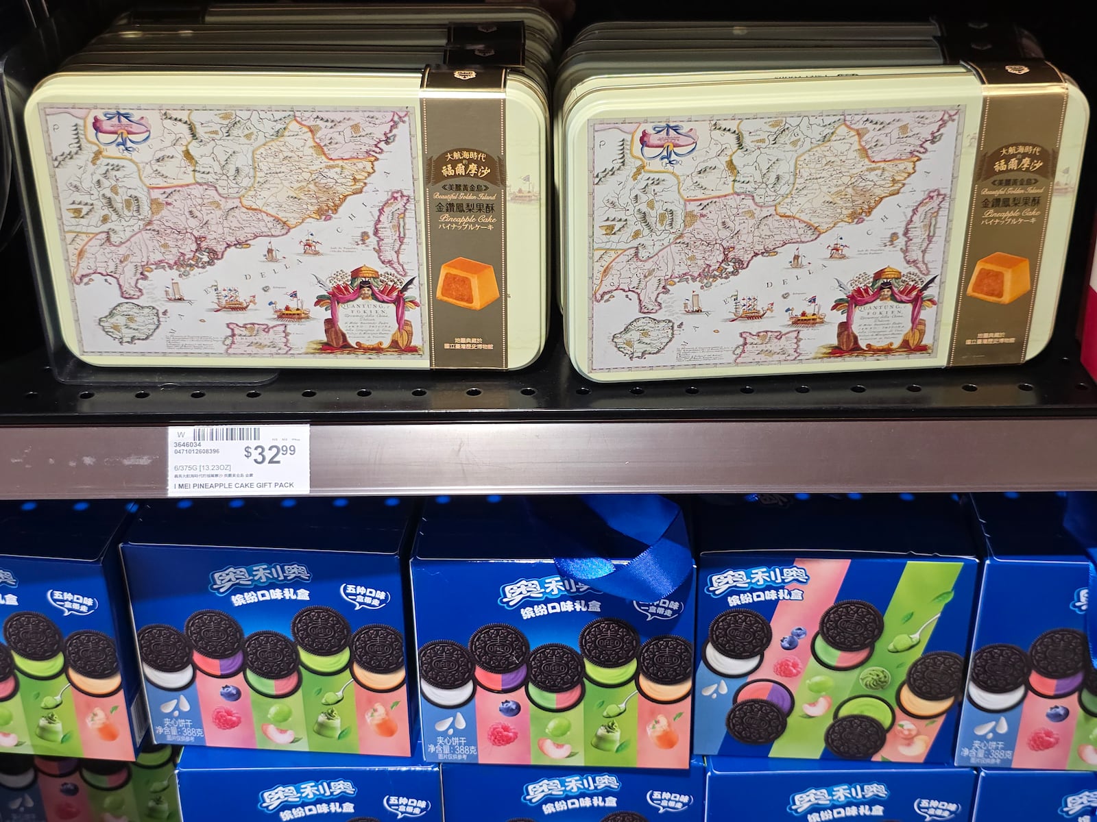 Imported Pineapple Cakes, sold in a metal tin box decorated with an old map of China, sits next to imported Oreo cream-filled cookies sold at 99 Ranch Market, an Asian grocery store in Los Angeles Monday, April 7, 2025. (AP Photo/Damian Dovarganes)