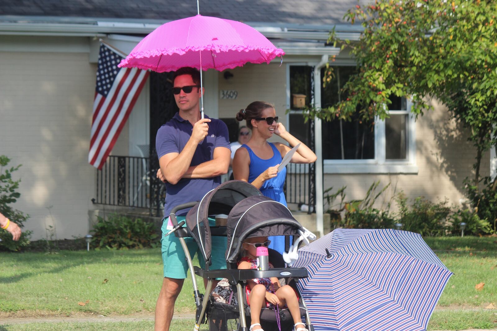 Holiday at Home spectators brought along their own shade to keep cool. STAFF PHOTO/Chuck Hamlin