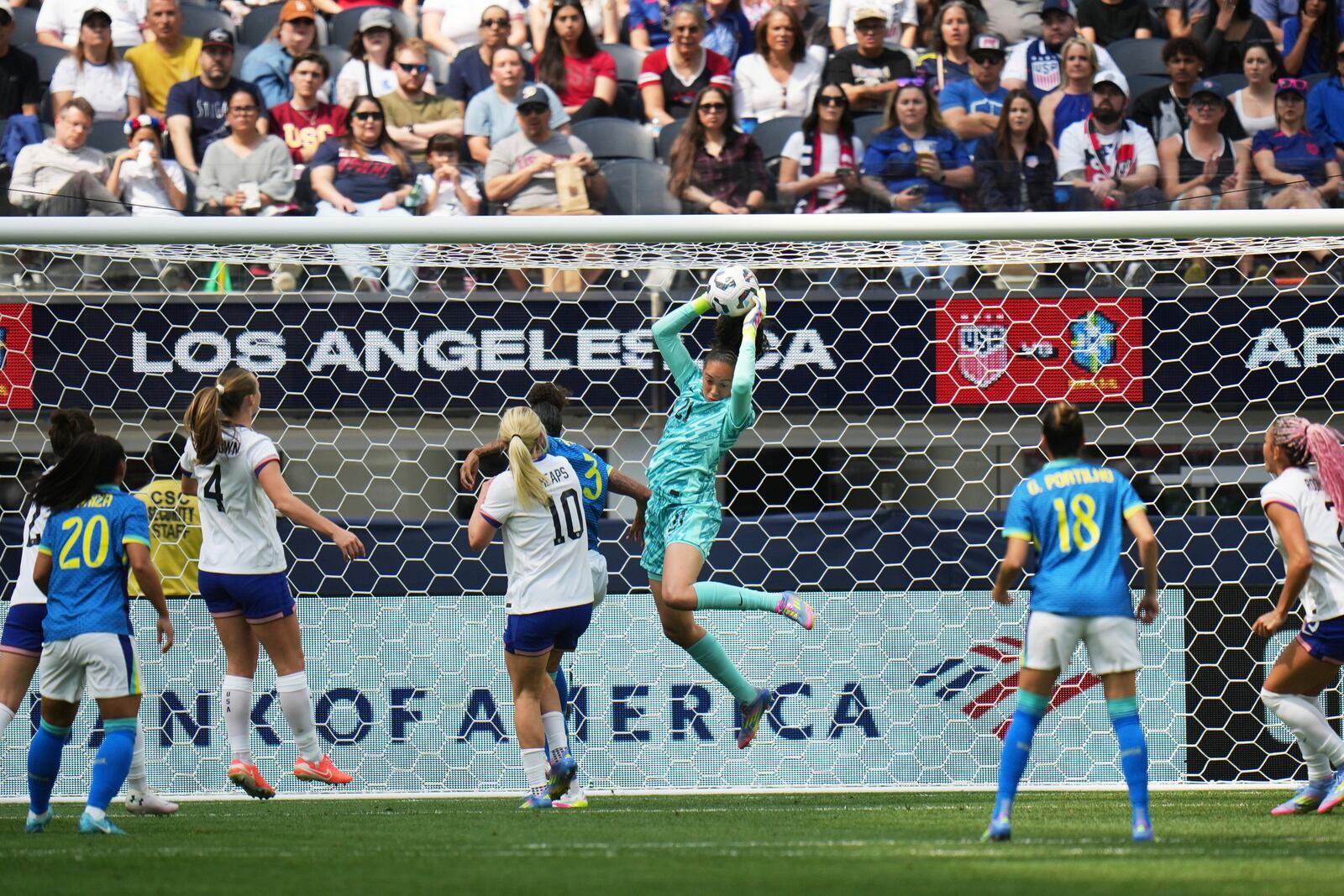 United States goalkeeper Phallon Tullis-Joyce (21) makes a save against Brazil defender Tarciane (3) during the first half of a women's international friendly soccer match in Inglewood, Calif. Saturday, April 5, 2025. (AP Photo/Jae C. Hong)
