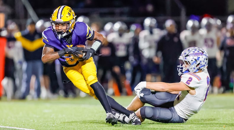 Springfield High School senior Sherrod Lay, Jr. breaks free from Marysville's JJ Henry during their game on Friday, Oct. 31 at Wildcat Stadium. Springfield won 35-6. MICHAEL COOPER / STAFF PHOTO