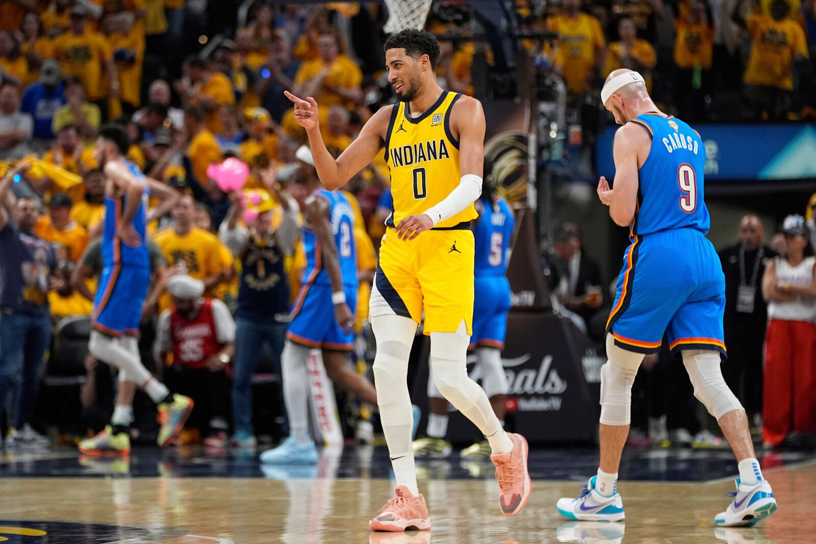 Indiana Pacers guard Tyrese Haliburton (0) points after a basket against the Oklahoma City Thunder during the second half of Game 6 of the NBA Finals basketball series, Thursday, June 19, 2025, in Indianapolis. (AP Photo/Abbie Parr)
