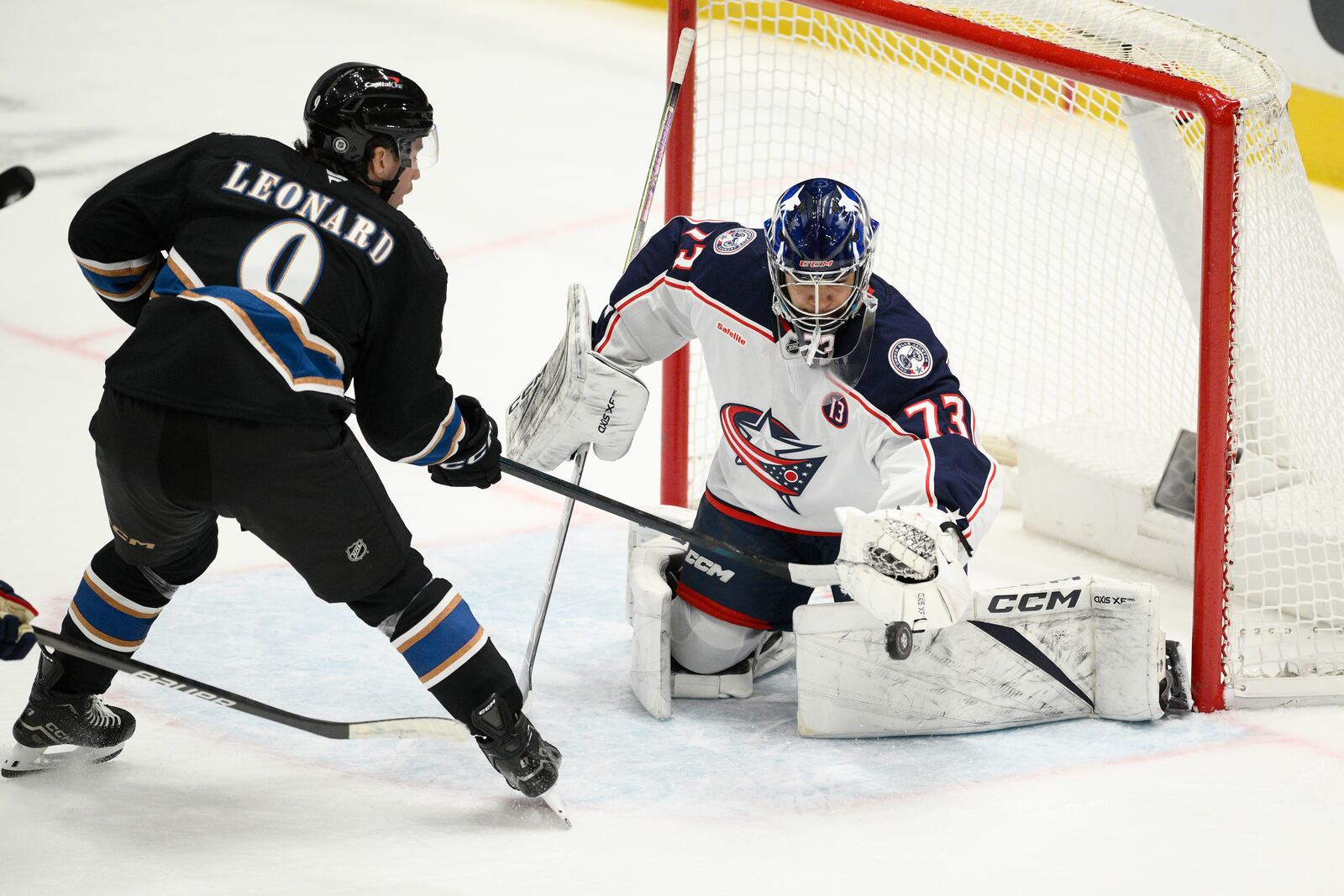 Washington Capitals right wing Ryan Leonard (9) tries to get the puck past Columbus Blue Jackets goaltender Jet Greaves (73) during the third period of an NHL hockey game, Sunday, April 13, 2025, in Washington. (AP Photo/Nick Wass)