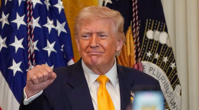 President Donald Trump gestures during a Black History Month event in the East Room of the White House, Wednesday, Feb. 18, 2026, in Washington. (AP Photo/Nathan Howard)