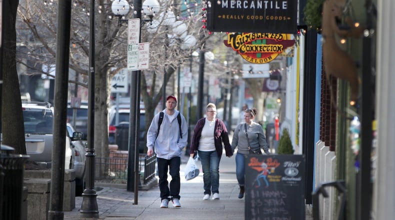 Shoppers stroll through the Dayton’s Oregon District Monday. It’s been six months since a gunman killed nine people there in a mass shooting. LISA POWELL / STAFF