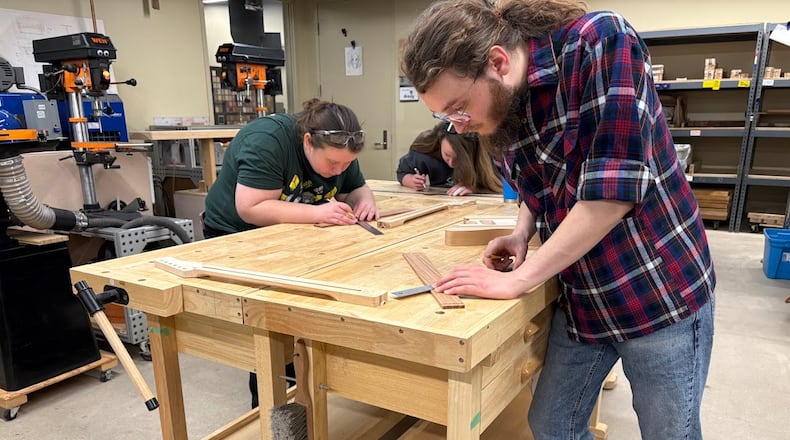 Steffin Woods, a Sinclair Community College student, measures a guitar fretboard in Sinclair's Guitar Lab on Saturday Feb. 7, 2026. The class applies basic math and physics, as well as machining skills, to the art of guitar-building. THOMAS GNAU/STAFF