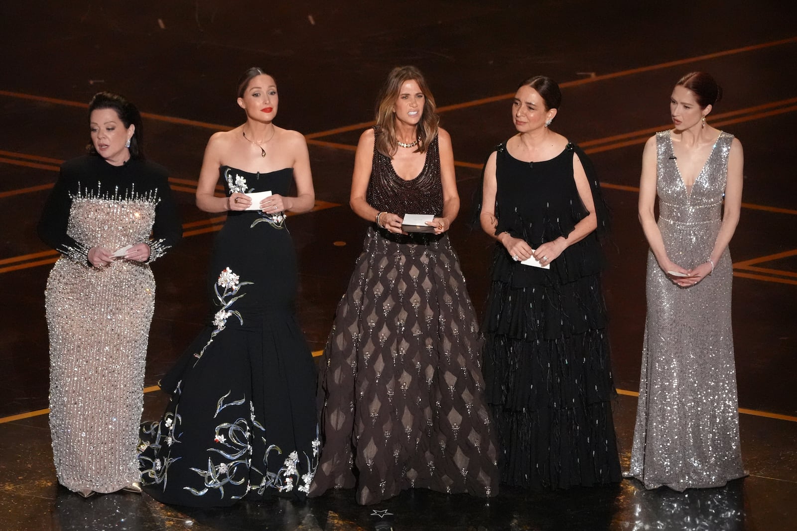 Melissa McCarthy, from left, Rose Byrne, Kristen Wiig, Maya Rudolph, and Ellie Kemper present the award for best original score during the Oscars on Sunday, March 15, 2026, at the Dolby Theatre in Los Angeles. (AP Photo/Chris Pizzello)